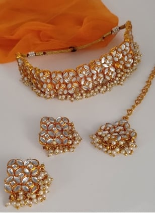 Gold and White choker set enhanced with Kundan