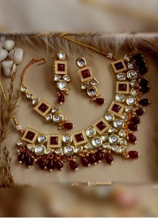 Jewellery Set in Maroon Enhanced with Kundan