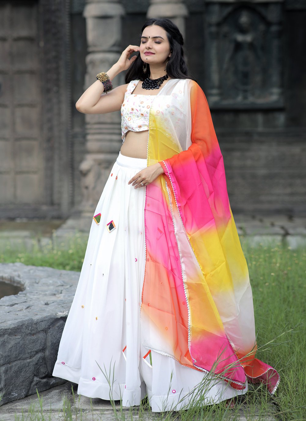 IVORY WHITE COLOURFUL BANARASI LEHENGA SET WITH A MULTI COLOURED HAND  EMBROIDERED BLOUSE PAIRED WITH A SHADED BANARASI DUPATTA AND SILVER  DETAILS. - Seasons India